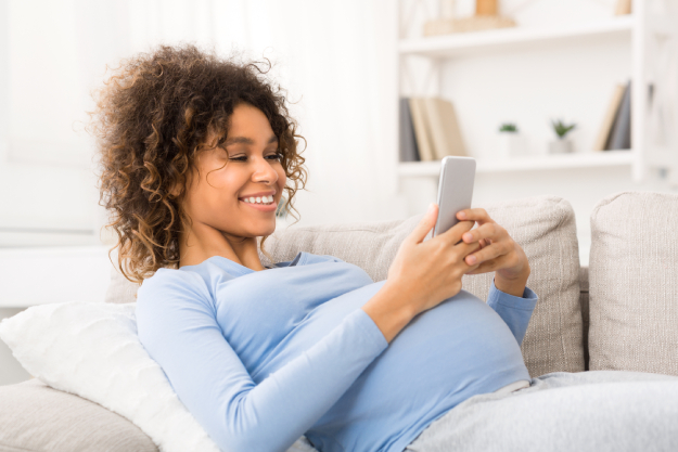 A pregnent lady busey with her device