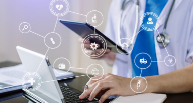 Doctor using laptop and tablet with medical icons overlay